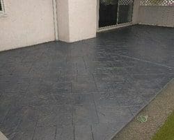 alt="small patio stamped concrete flagstone"