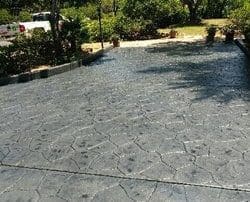 alt="large stamped concrete driveway installation and grey colored staining and sealing in Poway San Diego"